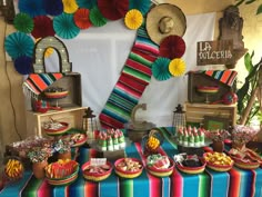 a colorful table topped with lots of food