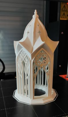 a paper model of a white building on a table