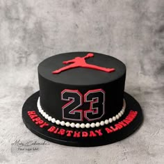 a black and red birthday cake with the number twenty two