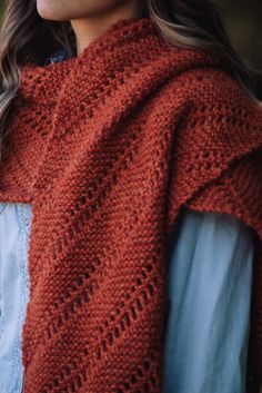 a woman wearing a red knitted shawl