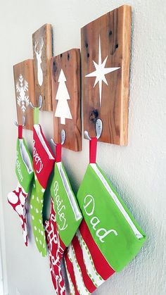 three christmas stockings hanging from hooks on a wall