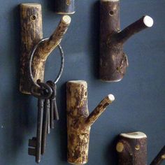 several pieces of wood are arranged on the wall with keys attached to them and hanging from hooks