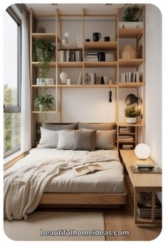 a bed sitting under a window next to a wooden shelf filled with lots of books