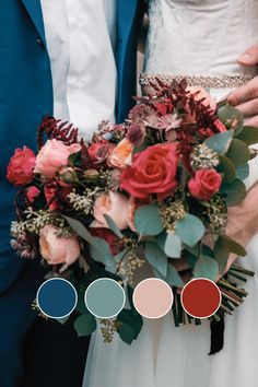 the bride and groom are holding their wedding bouquet with different shades of red, pink, blue