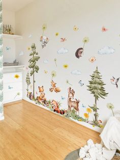 a child's room with wallpaper and wooden flooring, including an animal mural