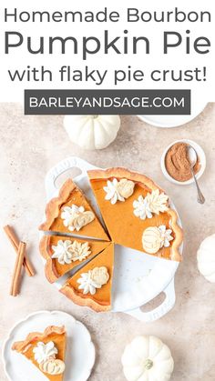 homemade bourbon pumpkin pie with flaky pie crust on a white platter, surrounded by mini pumpkins and cinnamon sticks