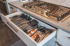 an open drawer with utensils in it