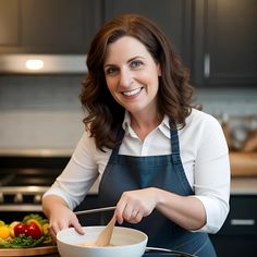 a woman in an apron is mixing something in a bowl