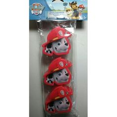 three little puppies wearing fire hats on top of each other's heads in plastic packaging