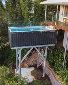 an above ground swimming pool in the middle of a yard with trees and bushes surrounding it