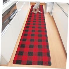 a red and black checkered rug in a kitchen