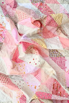 a quilt made with pink and white fabric