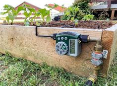 a meter attached to a wooden planter box