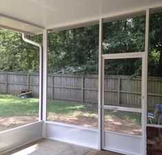 an empty room with sliding glass doors on the outside and grass in the back yard