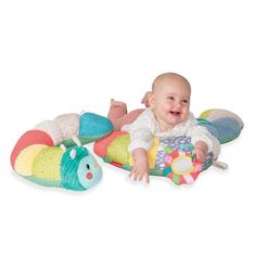 a baby laying on top of a colorful toy