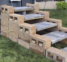 an outdoor bench made out of cinder blocks