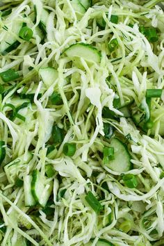 shredded cucumbers and green onions are mixed together in a salad with sesame seeds