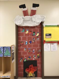 a door decorated with magnets and paper on the wall, in front of a red brick wall