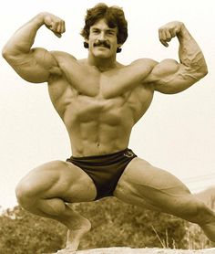 a man posing for the camera while flexing his muscles