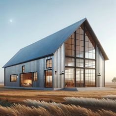 a large metal building sitting on top of a dry grass field