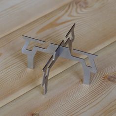 a piece of metal sitting on top of a wooden table