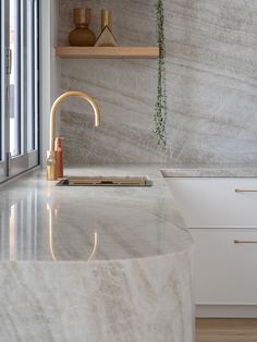 a kitchen with marble counter tops and open shelving on the wall above it is captioned captioned captioned captioned caption