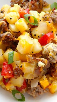 a white plate topped with pasta and meat covered in cheese, peppers and seasoning