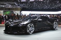 a black sports car on display at an auto show