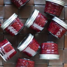 several jars filled with red liquid sitting on top of a table