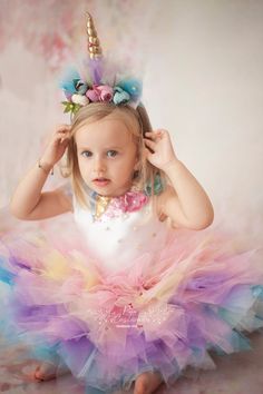 This mini Unicorn Costume for Toddler is perfect for unicorn themed party, photo shootings, Halloween, pageants and for many other occasions.   This Unicorn Birthday dress has a fluffy tutu skirt made of plenty layers of pastel rainbow colors and the bodice has a charming heart-shaped opening detail and a zipper on the back.  It is made of highest quality non-allergic mikado, satin and plenty layers of tulle, and embellished with applique sequined fabric, artificial flowers and rhinestones.  The horn headband handmade of lame fabric, artificial fabric roses and tulle is included. This first birthday dress is a great gift for girls. Handmade and customized for your own size. Made to Order  Gift message available Shipped from Turkey Please note: The actual color may vary from picture due to Pink Unicorn Costume, Unicorn Birthday Dress, Pastel Rainbow Colors, Rainbow Unicorn Birthday Party, Unicorn Halloween Costume, Motto Party, Sequined Fabric, Rainbow Unicorn Birthday, Lame Fabric