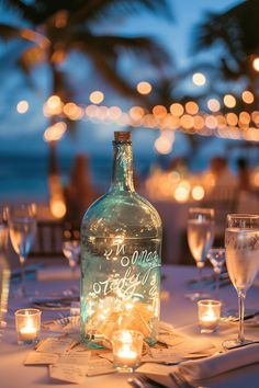 an empty bottle sitting on top of a table next to wine glasses and napkins