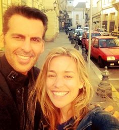 a man and woman taking a selfie in the street