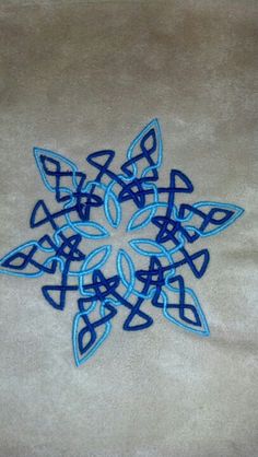 a blue and white snowflake sitting on top of a rug