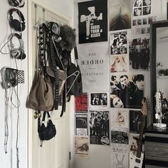 there is a wall with posters and other items on it in the room that has been decorated