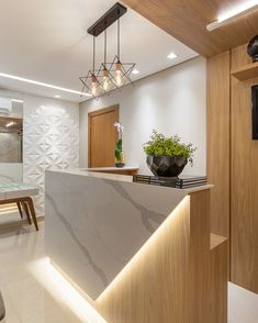 a kitchen with a marble counter top next to a dining room table