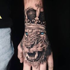 a hand with a tiger wearing a crown on it's head and blue eyes