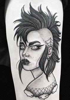 a woman's face with black hair and tattoos on her leg