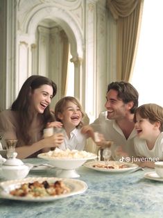 a group of people sitting around a table with food and drinks in front of them