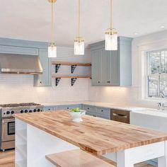 a kitchen with wooden counter tops and stainless steel appliances