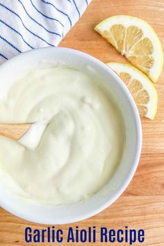 a bowl of yogurt next to sliced lemons on a cutting board with the words garlic aloi recipe