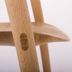 a close up of a wooden chair with an oval hole in the back and side