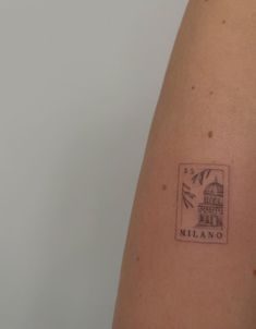 a stamp on the back of a woman's arm that says, milano