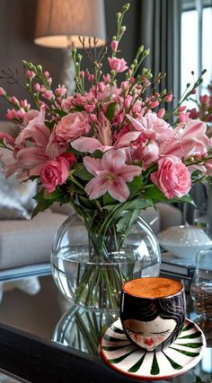 pink flowers in a vase on a coffee table