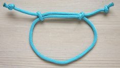 a close up of a blue rope on a wooden surface