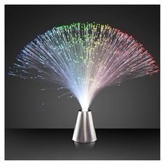 a colorful light up display on top of a metal vase with lights coming out of it