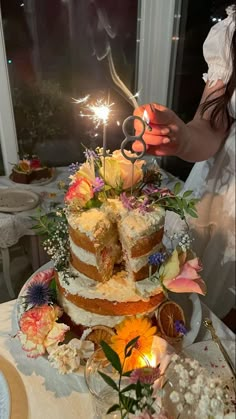 a woman cutting into a cake with a pair of scissors