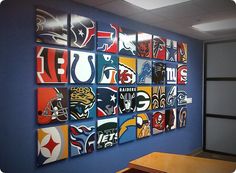 a wall with many different nfl logos on it and a wooden table in the foreground