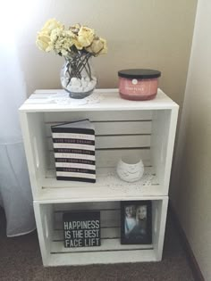 a white shelf with flowers and pictures on it