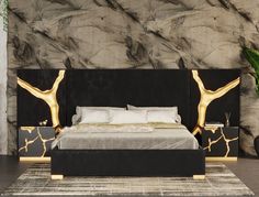 a modern bedroom with black and gold decor, including a large bed in front of a stone wall