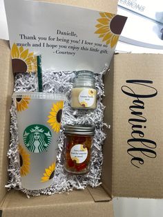 the starbucks gift box is packed with two mugs, a jar of honey and a cup of coffee